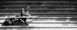 Waxing surfboard on steps