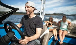 Grant Korgan driving a Supreme S238 with two women