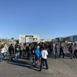 A group of people standing in a parking lot near Supreme Boats.