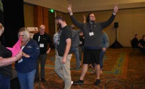 A group of people waving their hands in the air.