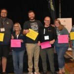 A group of people posing with their Supreme Boats certificates.