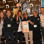 A group of people posing for a picture at a Supreme Boats event.