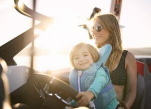 Supreme smiling mom and child in drivers seat