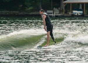 Disabled man wake surfing
