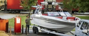 A male and female couple filling up a Supreme boat at the gas pump