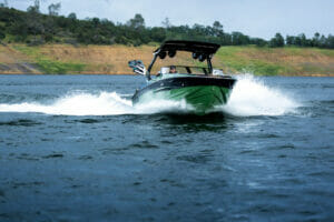 Supreme S240 boat cutting through rough water