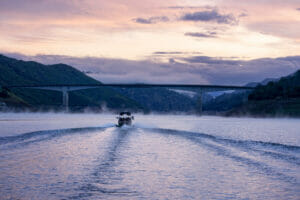 Supreme S240 boat driving away into the horizon