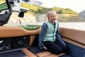 Child sitting in a Supreme S240 boat
