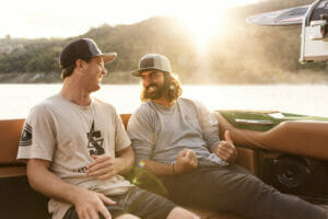 Two men smiling in a Supreme S240 boat