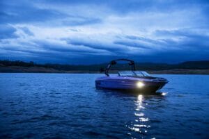 Supreme Boats navigating on a lake at dusk.