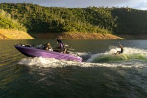 A group of people riding a Supreme boat on a lake.