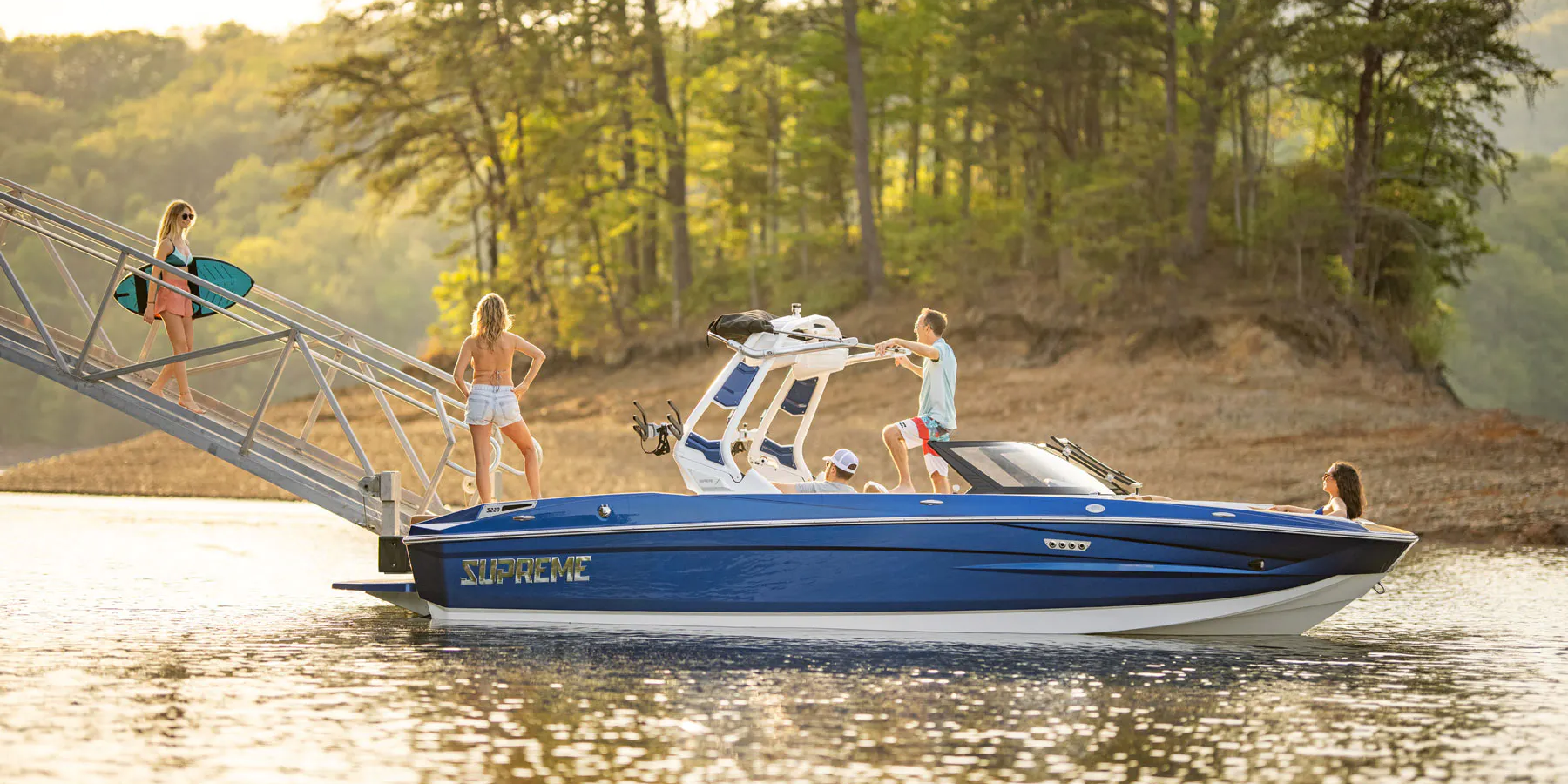 Woman walking down boat ramp to a Supreme boat