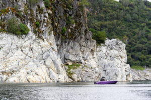 Purple S220 Supreme boat far away in lake