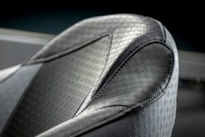 Close-up of a textured, patterned car seat with detailed stitching in shades of gray and black, inspired by the premium design found in the Supreme S220.