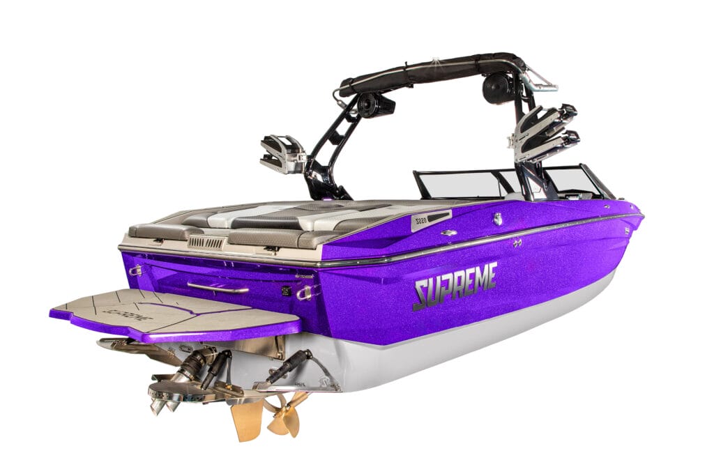 A purple 2026 Supreme Towboats S220 wakeboard boat with a rear swim platform, black tower, and visible propellers, photographed on a white background.