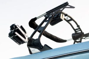 Close-up of a wakeboard rack and tower mounted on a 2026 Supreme Boats S240, with sleek metal and black components visible against a clear sky background.