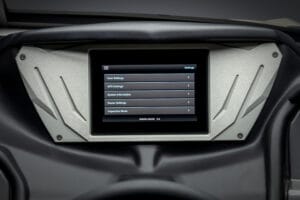 A touchscreen display shows a settings menu with options for user settings, GPS settings, system information, dealer settings, and inspection mode on the Supreme S240.