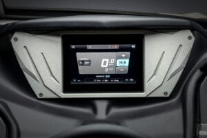 A digital dashboard display in the Supreme Boats S240 shows speed, RPM, battery status, and other indicators on a rectangular screen set in a metallic frame.