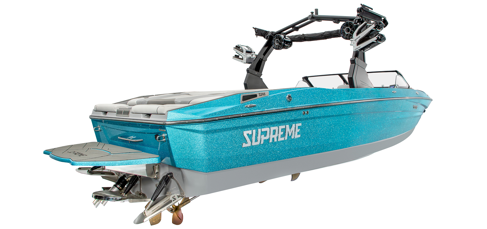 A blue Supreme Boats S240 wakeboard boat with a rear swim platform and two wakeboard towers, viewed angled from the back right side.