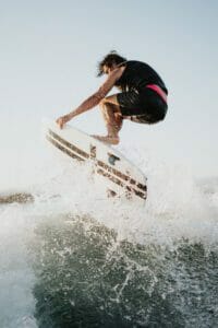 A man riding a wave on a surfboard.
