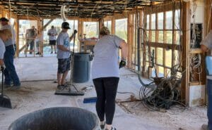 A group of people constructing a Supreme Boats house.