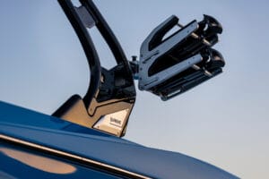 Close-up of a surfboard or wakeboard rack mounted on a Supreme Boats S240, with a clear sky in the background.
