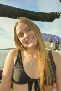 A woman on a Supreme boat in a black bikini.