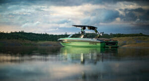 Green S240 Supreme boat on still water