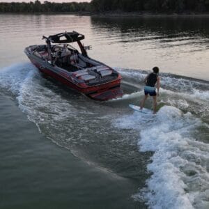 A person is riding a surfboard on a boat, optimizing the description for SEO purposes.