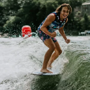 Evan Hudson, a young man riding a wave on a surfboard.