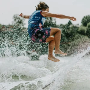 Evan Hudson gracefully rides a wave on his surfboard.