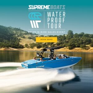 A blue Supreme Wake Boat speeds across the lake with four people aboard. The "Water Proof Tour" poster features "Drive-N-Ride Sales Event" and "Book Demo" overlays, showcasing the ultimate experience with Supreme.